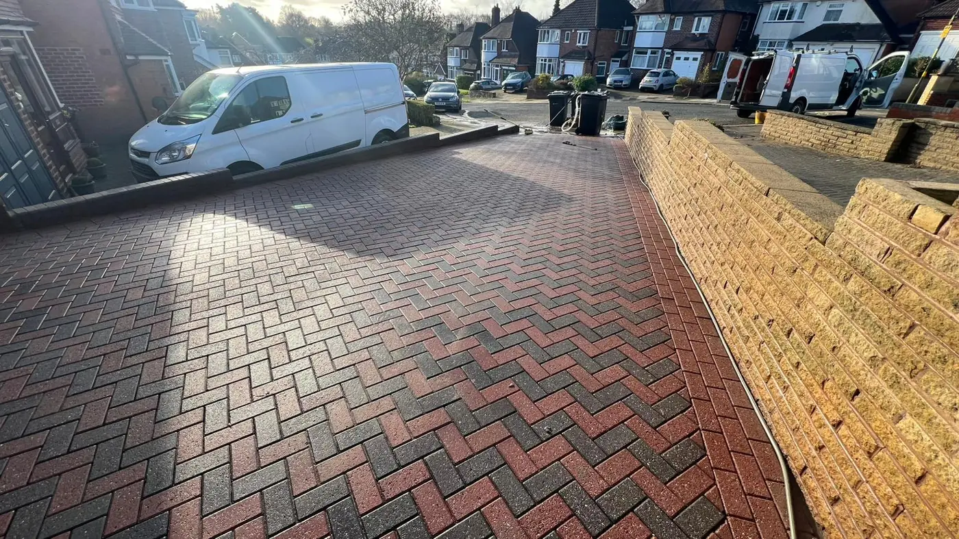 Wide view of a freshly jet washed driveway in Bromsgrove with the All Saints van in shot