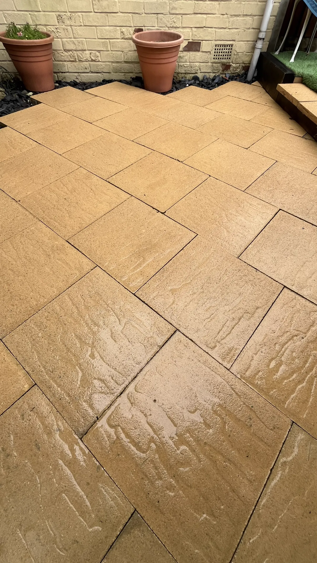 Before and after jet washing a garden path