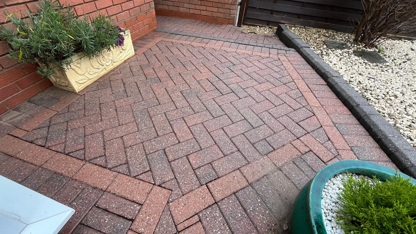 Clean block paved entryway patio after jet washing