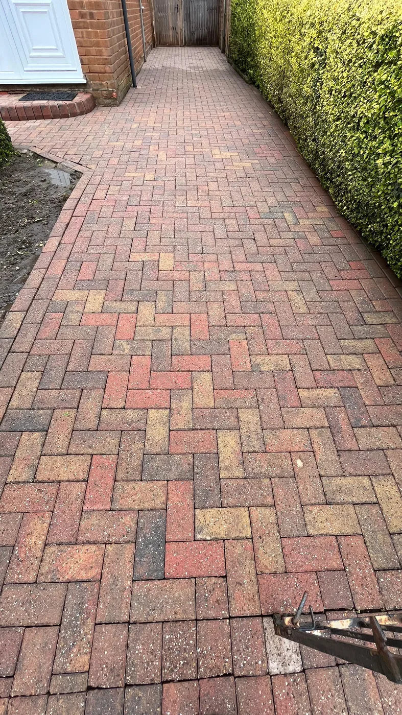 Clean block paved side alley path after moss removal