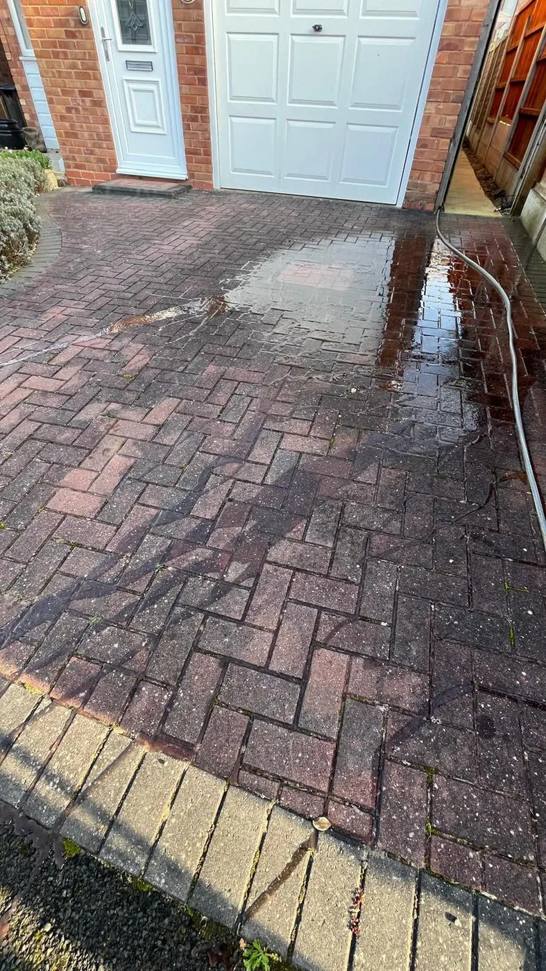 Dirty block paved driveway before jet washing