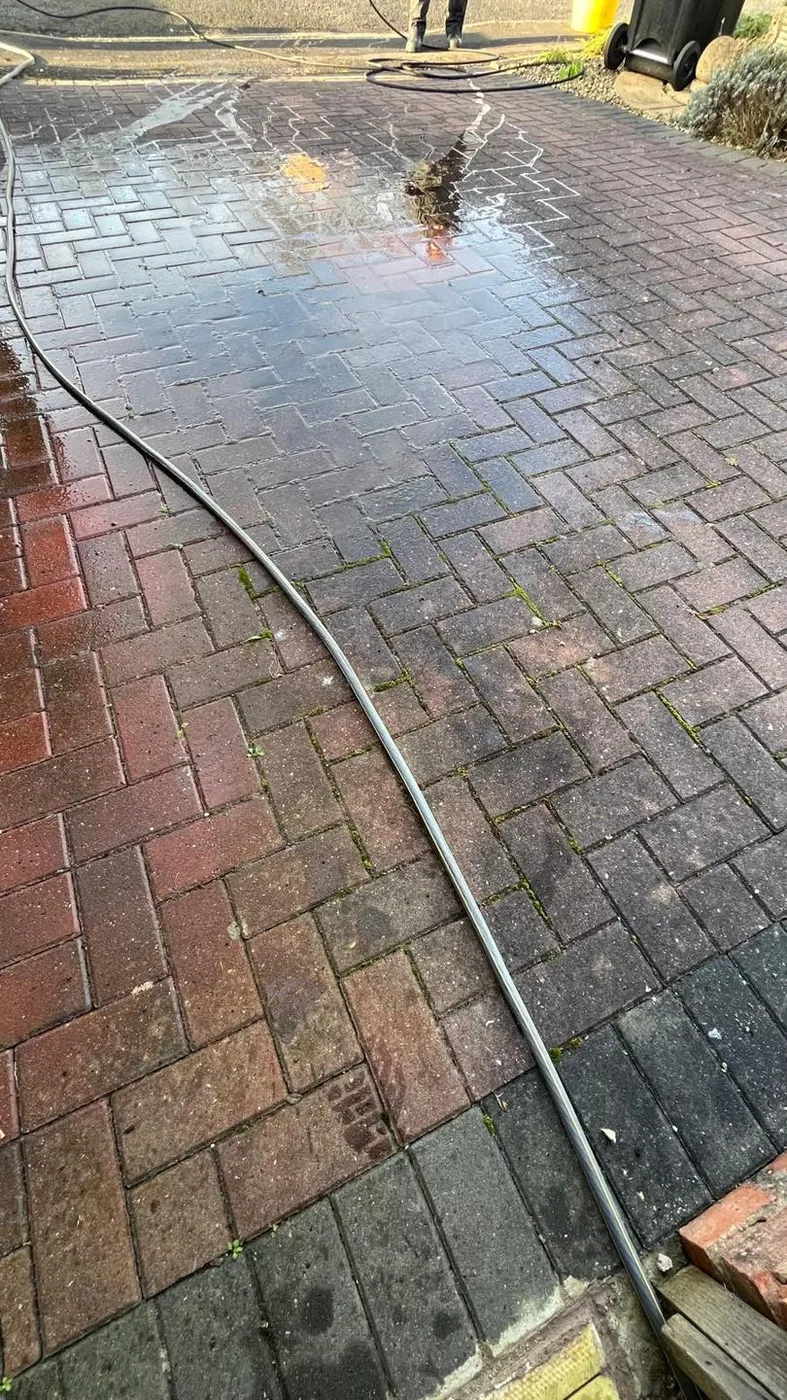 Dirty, moss-covered block paved driveway before cleaning